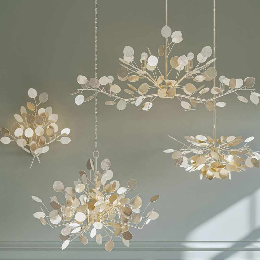 Layered lighting design with sculptural branch chandeliers and sconces